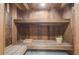 Custom sauna room featuring wood walls, bench seating, and a wooden bucket with ladle at 6014 Crystal View Dr, Orlando, FL 32819