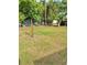 Spacious backyard with a chain link fence surrounded by mature trees at 602 Nw 1St Ave, Mulberry, FL 33860