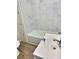 Bathroom featuring shower-tub combination, granite countertops, and modern white cabinets at 602 Nw 1St Ave, Mulberry, FL 33860