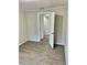 Bedroom showing modern grey floors, neutral colored walls, and a doorway to another room at 602 Nw 1St Ave, Mulberry, FL 33860