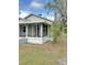 Exterior view of the home showing the screened-in porch and mature trees at 602 Nw 1St Ave, Mulberry, FL 33860