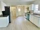A kitchen with stainless steel appliances, white cabinets and granite countertops at 602 Nw 1St Ave, Mulberry, FL 33860