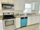 Well-lit kitchen featuring stainless steel appliances, granite counters, and white cabinets at 602 Nw 1St Ave, Mulberry, FL 33860