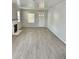 Spacious living room features updated flooring, neutral paint and a decorative fireplace at 602 Nw 1St Ave, Mulberry, FL 33860