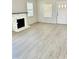 Bright living room with original fireplace detail and plenty of natural light at 602 Nw 1St Ave, Mulberry, FL 33860