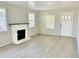 Light-filled living room with decorative fireplace at 602 Nw 1St Ave, Mulberry, FL 33860