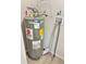 Image shows the water heater with a large Energy Guide sticker and related plumbing at 602 Nw 1St Ave, Mulberry, FL 33860