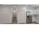 Hallway leading to the kitchen with luxury vinyl plank flooring and access to the attic at 612 Sears Ne Ave, Winter Haven, FL 33881
