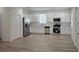 Open kitchen showcasing stainless steel appliances, white cabinets, and luxury vinyl plank flooring at 612 Sears Ne Ave, Winter Haven, FL 33881