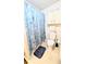 Bathroom featuring a shower with seashell-themed curtains at 6305 Bayberry Ne Blvd, Winter Haven, FL 33881