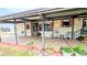 Inviting covered patio provides a relaxing outdoor space with comfortable seating and charming decor at 6305 Bayberry Ne Blvd, Winter Haven, FL 33881