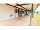 Spacious covered carport area with tiled floor offers ample parking and outdoor seating at 6305 Bayberry Ne Blvd, Winter Haven, FL 33881