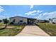 Single-story home with driveway and covered carport; perfect for parking and keeping vehicles protected at 6305 Bayberry Ne Blvd, Winter Haven, FL 33881