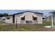 Rear exterior view showcasing mature landscaping and the home's overall curb appeal at 6305 Bayberry Ne Blvd, Winter Haven, FL 33881