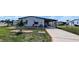 Charming home featuring well-maintained lawn, decorative flower beds, and a covered carport at 6305 Bayberry Ne Blvd, Winter Haven, FL 33881