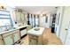 Spacious kitchen featuring an island, wood-look flooring, bright lighting, and ample cabinet space at 6305 Bayberry Ne Blvd, Winter Haven, FL 33881