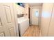 Functional laundry area includes washer, dryer, storage cabinets, and convenient access to the outdoors at 6305 Bayberry Ne Blvd, Winter Haven, FL 33881