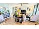 Inviting living room with light wood floors, a ceiling fan, and comfortable seating arrangements at 6305 Bayberry Ne Blvd, Winter Haven, FL 33881