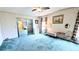 Bright main bedroom featuring carpeting, floral wallpaper, and an ensuite bathroom at 6305 Bayberry Ne Blvd, Winter Haven, FL 33881