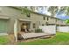 View of the private backyard featuring a brick paver patio, lawn, garden beds, and white vinyl fencing at 6343 Torrington Cir, Lakeland, FL 33811