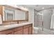Bathroom featuring double sink vanity, and glass enclosed shower at 6343 Torrington Cir, Lakeland, FL 33811