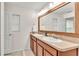 Bathroom featuring double sink vanity, large mirror, and a door to the water closet at 6343 Torrington Cir, Lakeland, FL 33811