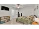 Cozy bedroom features stylish dresser, ceiling fan and comfortable bed for relaxation at 6343 Torrington Cir, Lakeland, FL 33811