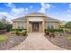 Charming clubhouse entrance with manicured landscaping and brick walkway at 6343 Torrington Cir, Lakeland, FL 33811