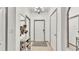 Welcoming foyer with neutral tones, stylish mirror, and convenient shoe rack at 6343 Torrington Cir, Lakeland, FL 33811