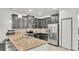 Modern kitchen with stainless steel appliances, granite countertops, ample storage and tiled backsplash at 6343 Torrington Cir, Lakeland, FL 33811