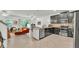 Open-concept kitchen with dark cabinets, stainless steel appliances, and breakfast bar at 6343 Torrington Cir, Lakeland, FL 33811