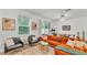 Well-lit living room featuring neutral colors, and a view of the backyard at 6343 Torrington Cir, Lakeland, FL 33811