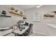 Well-lit home office with stylish wallpaper, floating shelves, and modern computer setup at 6343 Torrington Cir, Lakeland, FL 33811