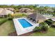 Community pool area with lounge chairs, a covered area and mature landscaping at 6343 Torrington Cir, Lakeland, FL 33811