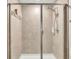 Elegant walk-in shower with glass doors and tiled walls, showcasing a modern design at 6343 Torrington Cir, Lakeland, FL 33811