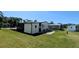 The house features a well-maintained backyard with green grass, enhancing the outdoor living experience at 6562 Chinaberry Ne Dr, Winter Haven, FL 33881