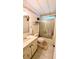 Cozy bathroom with shower and tub combo, vanity, decorative wallpaper border and wall decorations at 6562 Chinaberry Ne Dr, Winter Haven, FL 33881