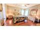 Inviting bedroom featuring hardwood floors, patterned wallpaper, and natural light at 6562 Chinaberry Ne Dr, Winter Haven, FL 33881