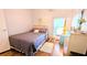Comfortable bedroom with hardwood floors, bright natural light, and ceiling fan at 6562 Chinaberry Ne Dr, Winter Haven, FL 33881