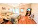 Comfortable bedroom with patterned wallpaper, hardwood flooring, and plenty of light at 6562 Chinaberry Ne Dr, Winter Haven, FL 33881
