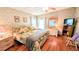 Cozy bedroom with patterned wallpaper, hardwood floors, and ample natural light at 6562 Chinaberry Ne Dr, Winter Haven, FL 33881