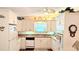 Bright kitchen featuring white cabinetry, modern appliances, and hardwood flooring at 6562 Chinaberry Ne Dr, Winter Haven, FL 33881