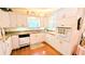 Charming kitchen with white cabinetry, hardwood floors, and modern appliances at 6562 Chinaberry Ne Dr, Winter Haven, FL 33881