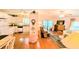 Open-concept living and dining area featuring hardwood floors and bright walls at 6562 Chinaberry Ne Dr, Winter Haven, FL 33881