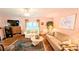 Warm and inviting living space featuring hardwood floors and bright walls at 6562 Chinaberry Ne Dr, Winter Haven, FL 33881