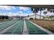 Enjoy recreational shuffleboard courts framed by palm trees in this active community at 6562 Chinaberry Ne Dr, Winter Haven, FL 33881