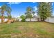 A fully fenced backyard features a playset, mature trees and a blank canvas ready for you to enjoy at 7120 Summit Dr, Winter Haven, FL 33884