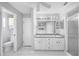 Bathroom with dual sinks, a walk-in shower, and a separate toilet area at 7120 Summit Dr, Winter Haven, FL 33884