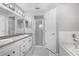Bathroom features dual sinks, a bathtub, and a separate shower at 7120 Summit Dr, Winter Haven, FL 33884
