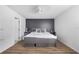 Bedroom with a gray bed frame, matching side tables, and a dark accent wall at 7120 Summit Dr, Winter Haven, FL 33884